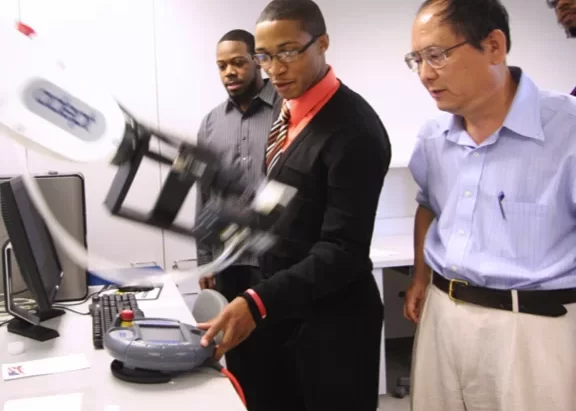 Dr. Ying Bai, a professor of computer engineering at JCSU, supervises student research for the CRC. Photo by Jeff Cravotta.