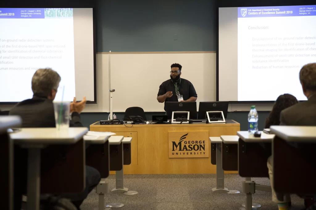 Johnson C. Smith University student William Case presented on behalf of the Purple Team at the COE Summit 2019's Grand Challenge event. Case's team won second place in the event.