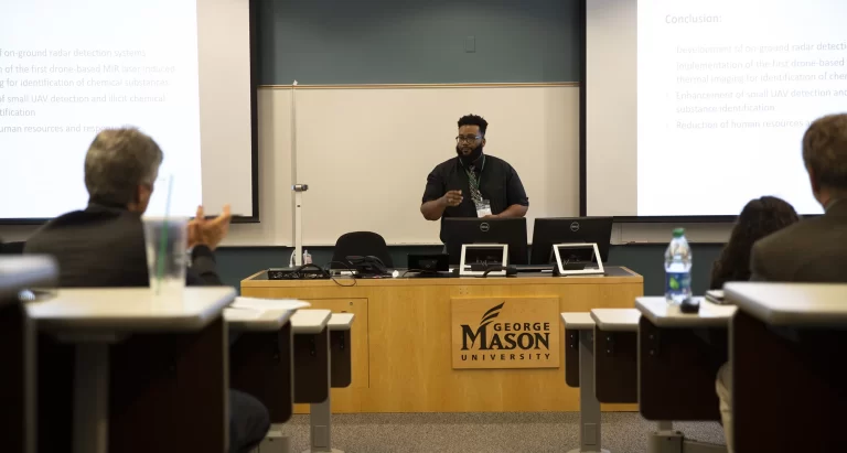 Johnson C. Smith University student William Case presented on behalf of the Purple Team at the COE Summit 2019's Grand Challenge event. Case's team won second place in the event.