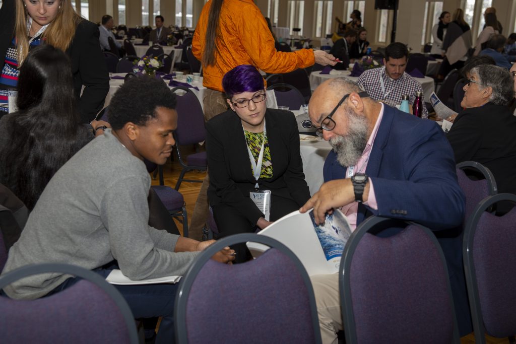 From left: CRC students Alex Halloway of UNC-Chapel Hill and Sarah Lipuma of Duke University discuss presentations with Cecilio Ortiz García, Senior RISE Fellow with the National Council for Science and the Environment. Photo By Brian Busher, University of Albany.