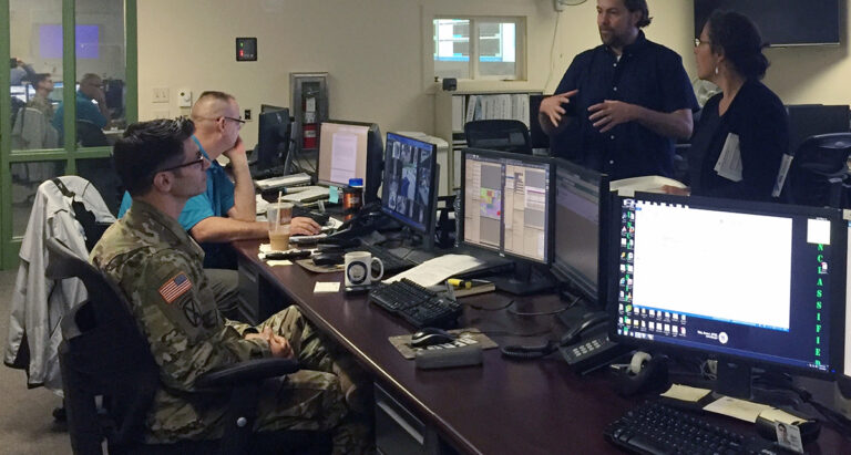 Pam Rubinoff, right, and Dr. Austin Becker, second from right, instruct participants in a June training on preparation for “Hurricane Rhody.” Photo via the University of Rhode Island.